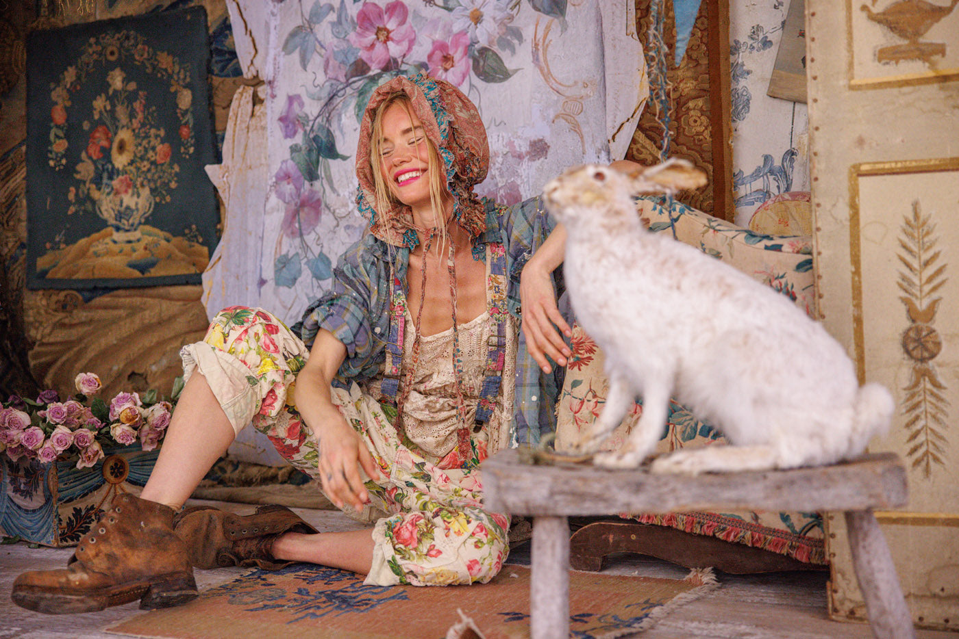 Woman in whimsical Magnolia Pearl artisan vintage floral clothing with bonnet, rustic decor, white rabbit