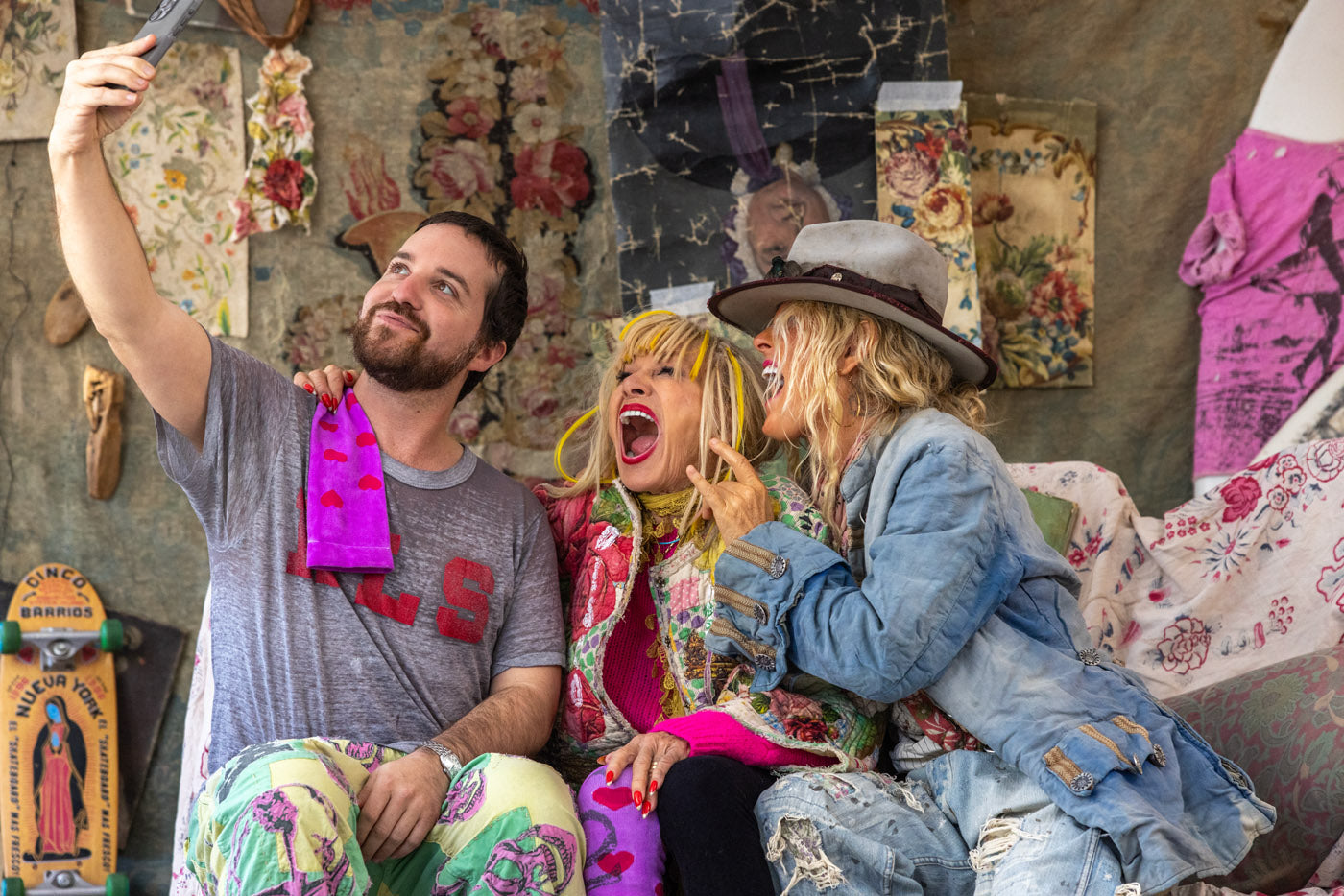 Three people in Magnolia Pearl artisan vintage clothing, whimsical designs, taking a selfie indoors