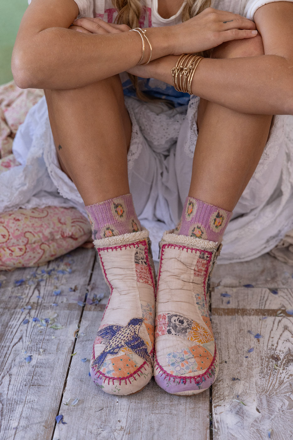 Magnolia Pearl artisan patchwork shoes with whimsical bird design and vintage style on rustic floor