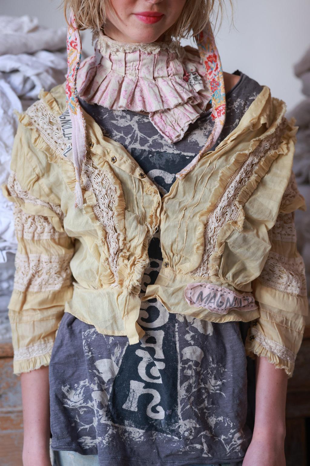 Woman wearing Magnolia Pearl artisan vintage lace jacket, whimsical layered boho style
