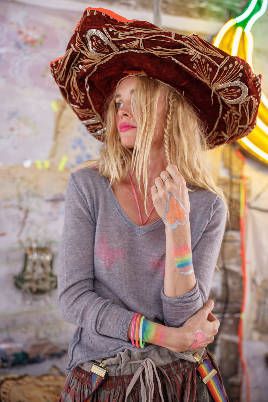 Woman in whimsical Magnolia Pearl artisan clothing, vintage style hat, hand-painted details