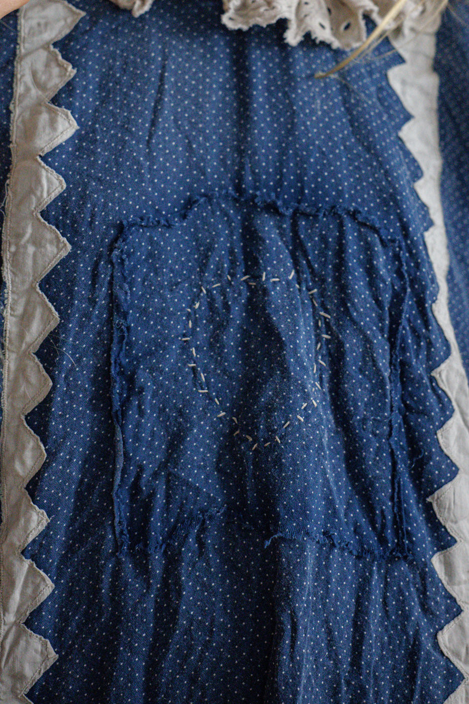 Magnolia Pearl artisan dress closeup, blue polka dot fabric, vintage patchwork and whimsical lace