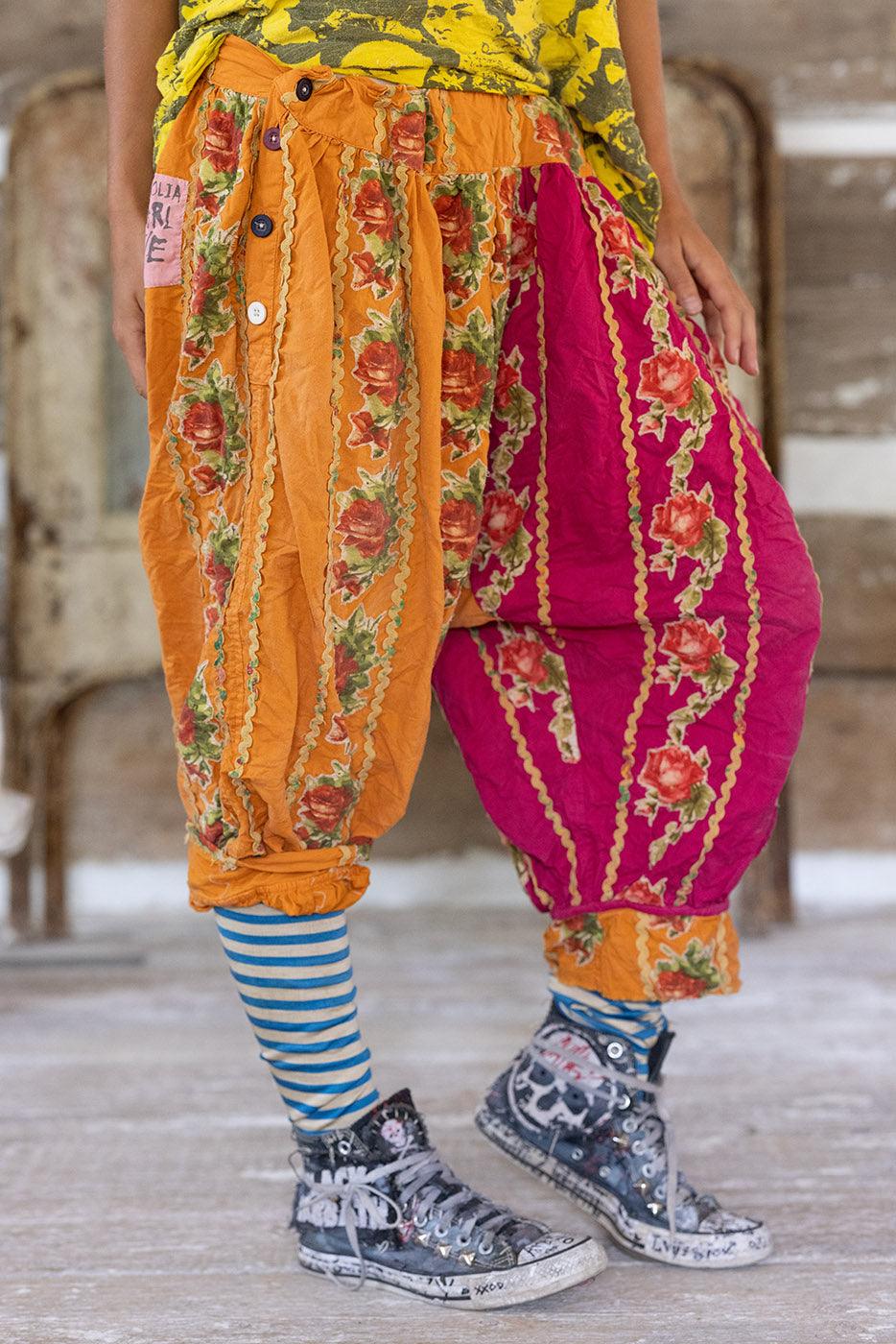 Magnolia Pearl whimsical artisan harem pants with vintage floral patchwork, striped socks, and distressed sneakers