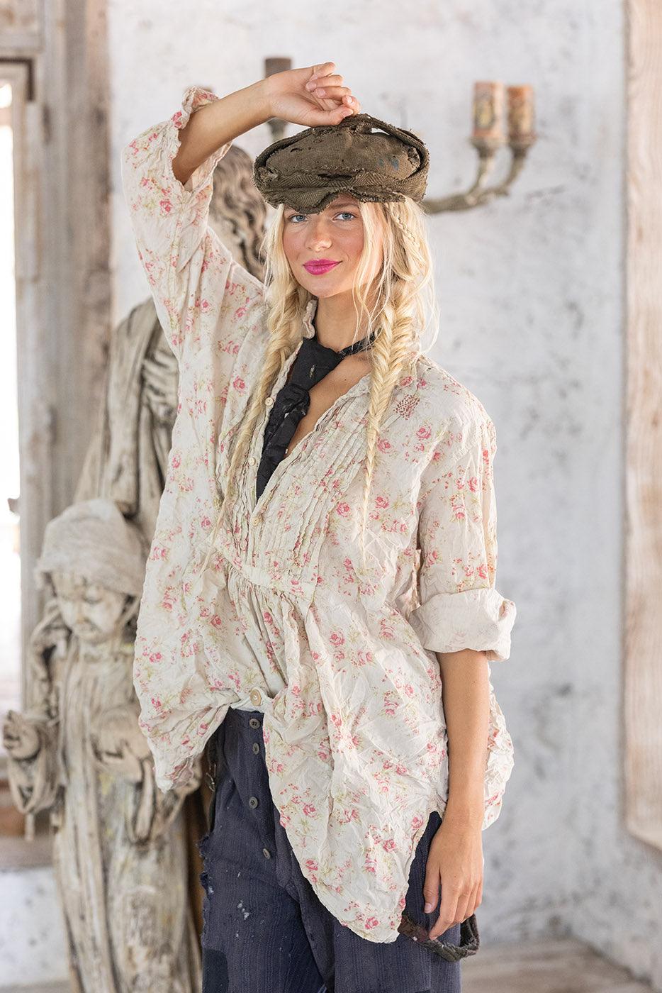 Woman in Magnolia Pearl vintage floral blouse and artisan hat, whimsical rustic setting