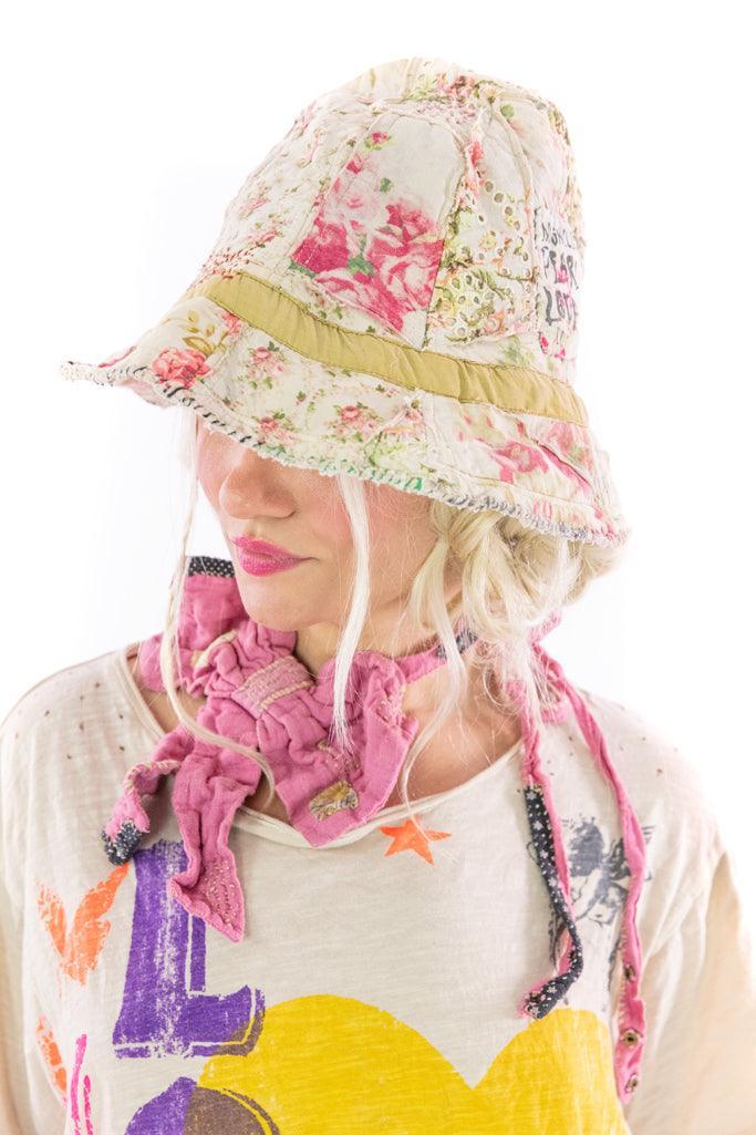 Magnolia Pearl floral patchwork bucket hat with vintage whimsical artisan style on model