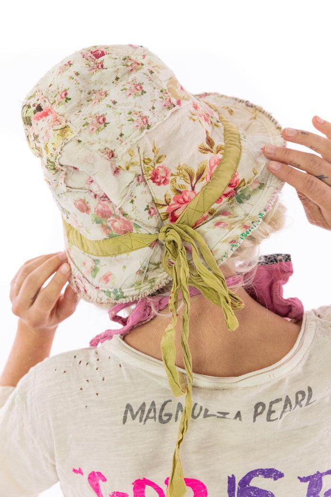 Magnolia Pearl artisan floral bucket hat with whimsical vintage style and green ribbon tie