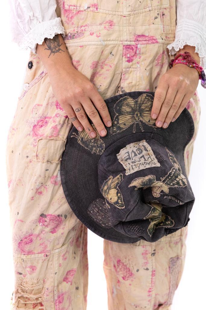 Magnolia Pearl artisan vintage overalls with pink floral pattern and whimsical butterfly hat