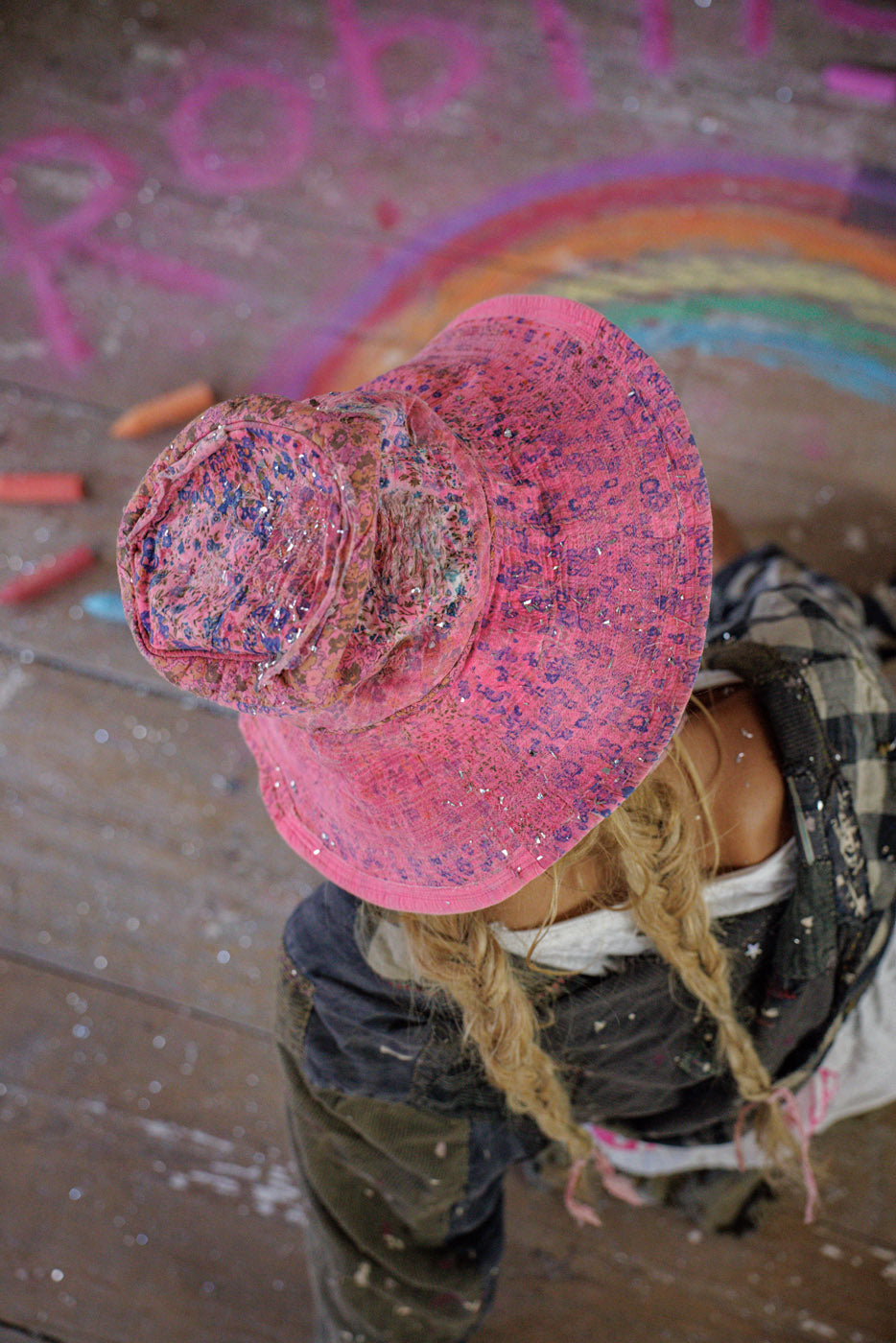 Magnolia Pearl artisan pink floral hat with whimsical vintage style, braids, rainbow chalk art