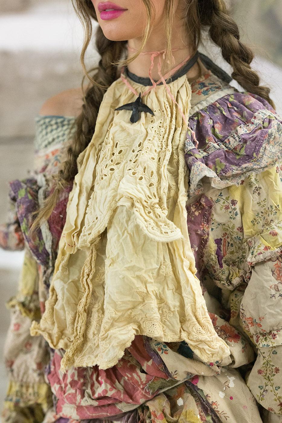 Woman in Magnolia Pearl vintage floral ruffle dress, whimsical artisan style, rustic setting