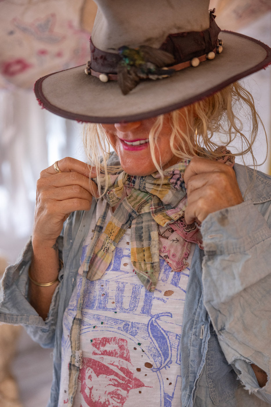Woman in Magnolia Pearl artisan vintage hat, patchwork scarf, whimsical t-shirt and denim jacket