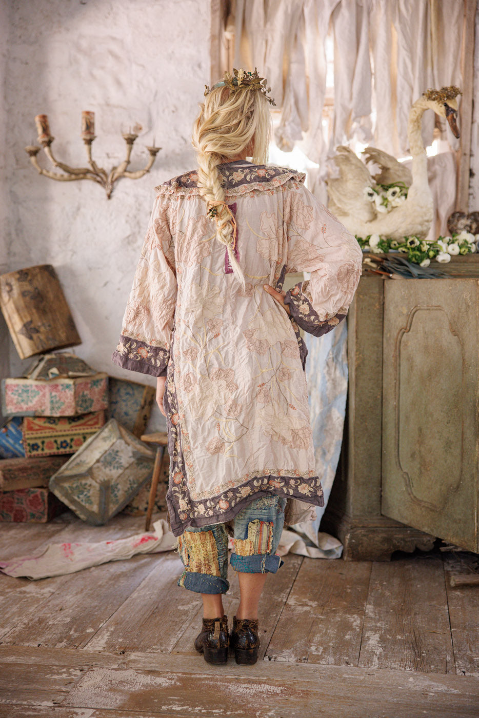 Magnolia Pearl vintage floral artisan jacket with whimsical design, worn in rustic setting
