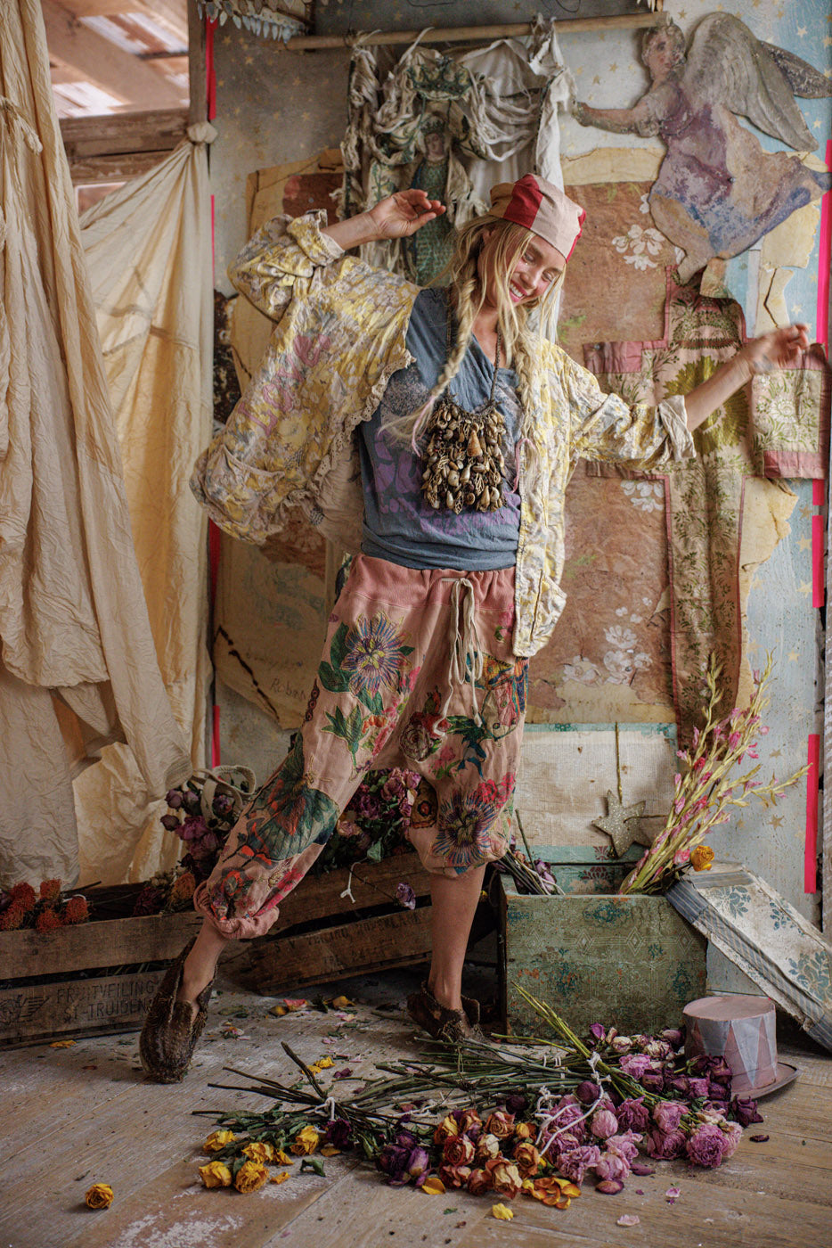 Magnolia Pearl artisan jacket with whimsical vintage floral design, woman in artistic boho setting