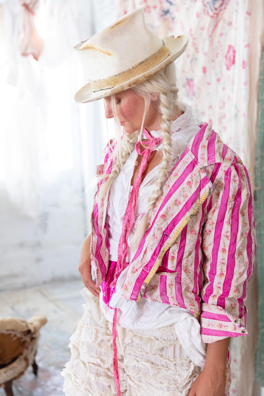Two women in Magnolia Pearl artisan vintage clothing and hats, smiling in a whimsical room