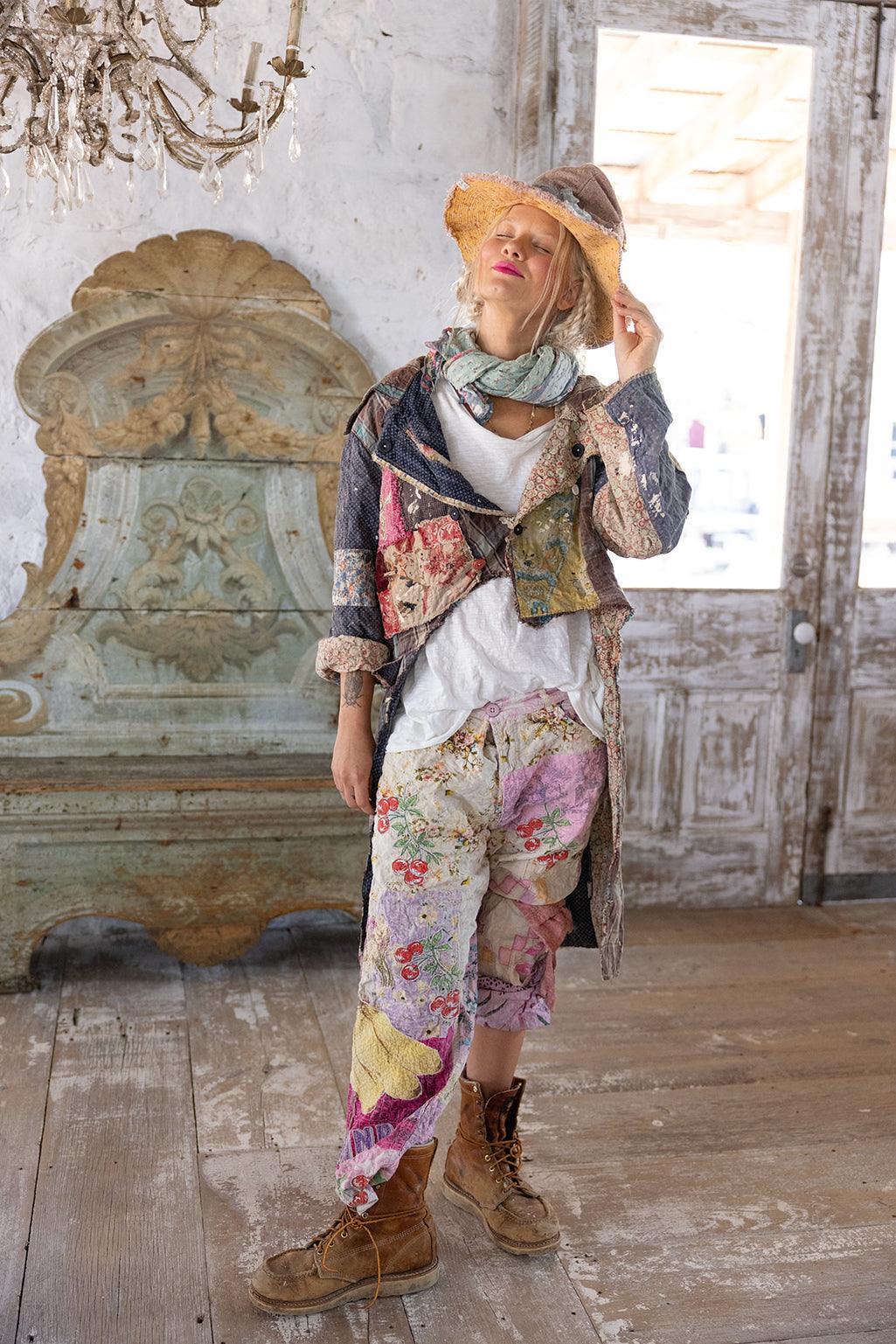 Woman wearing Magnolia Pearl artisan patchwork jacket and floral vintage pants in rustic room