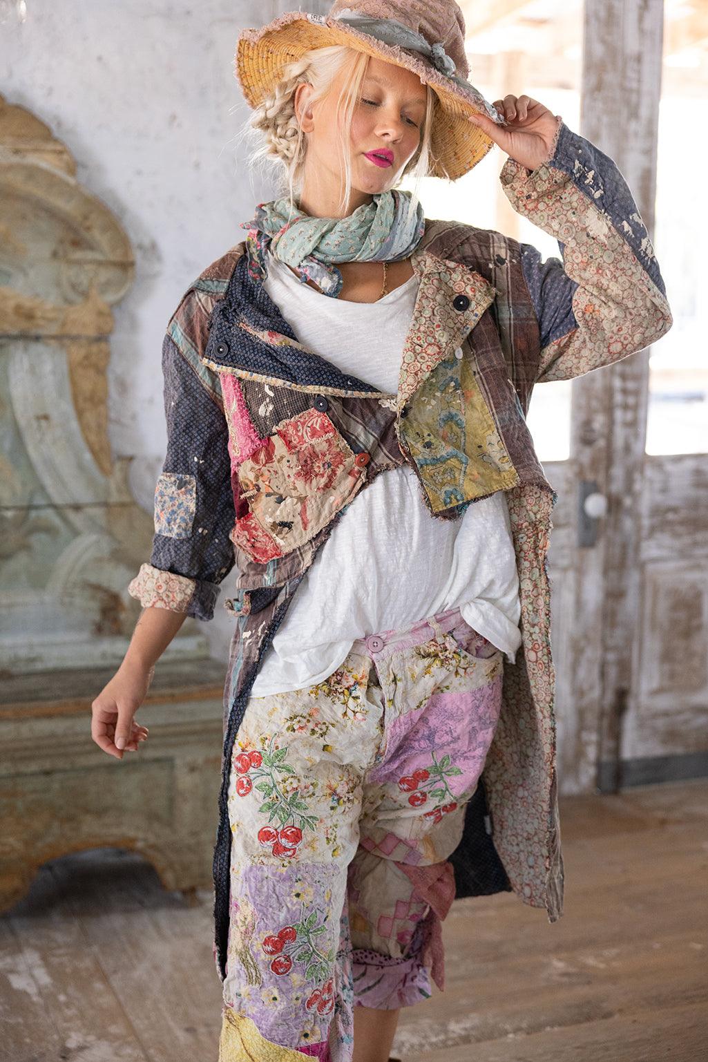 Woman wearing Magnolia Pearl artisan patchwork jacket and floral vintage pants in rustic room