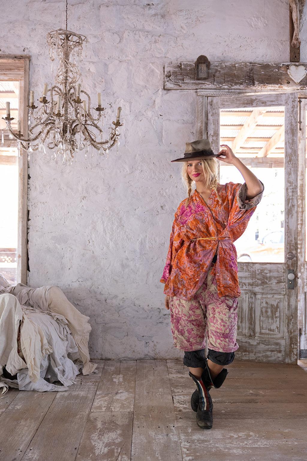 Woman in Magnolia Pearl artisan jacket and pants, vintage rustic room, whimsical style fashion