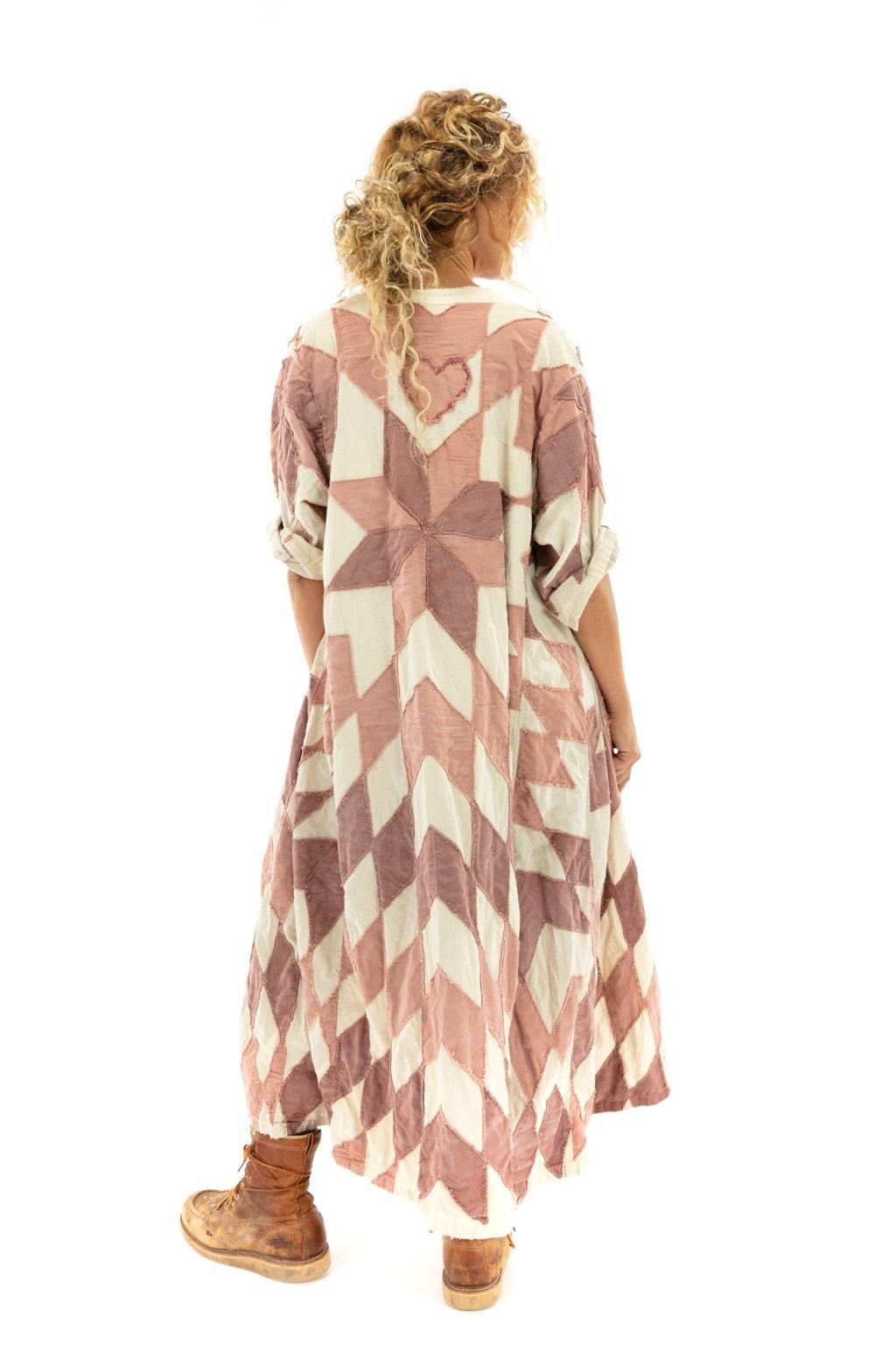 Woman in Magnolia Pearl artisan vintage duster jacket, whimsical patchwork outfit, and boots