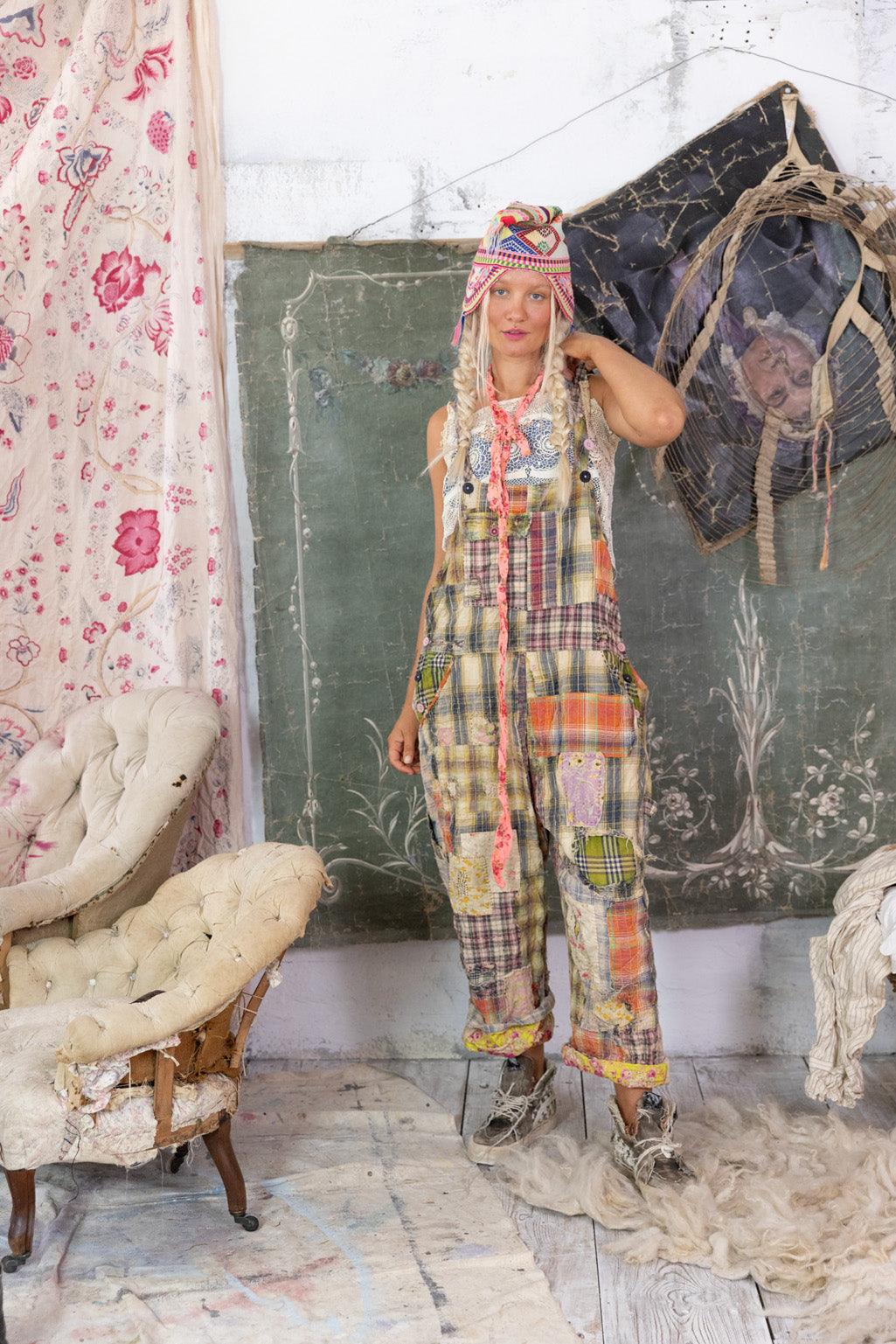 Woman in Magnolia Pearl patchwork overalls, vintage whimsical artisan clothing, eclectic room