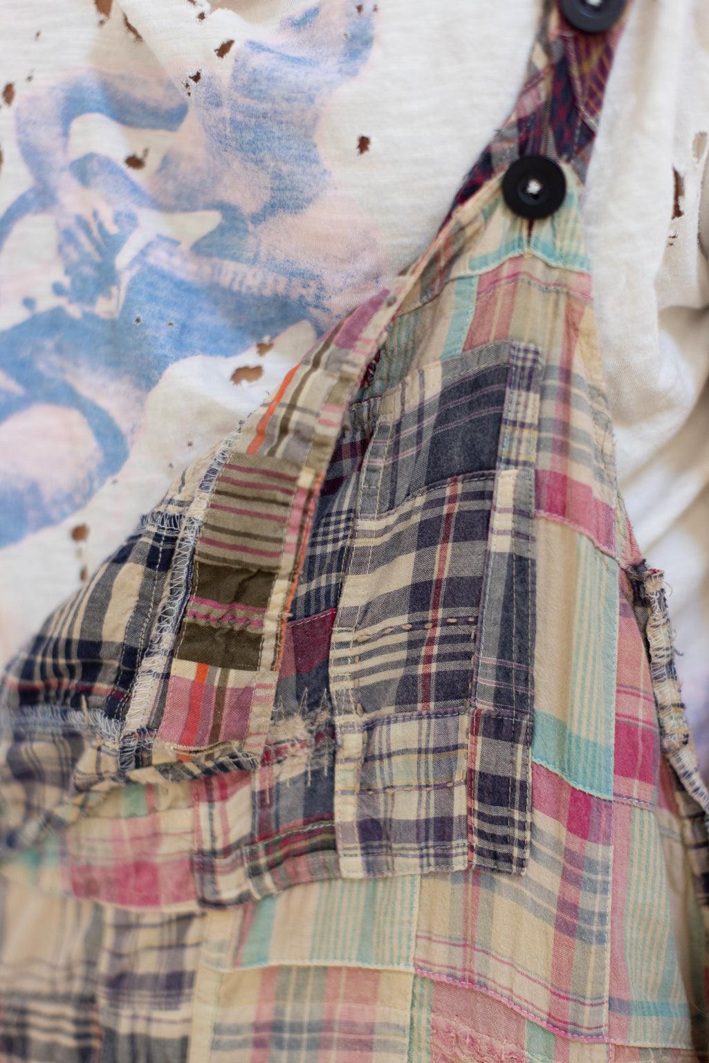 Man in Magnolia Pearl artisan patchwork overalls, distressed tee, whimsical accessories, vintage style