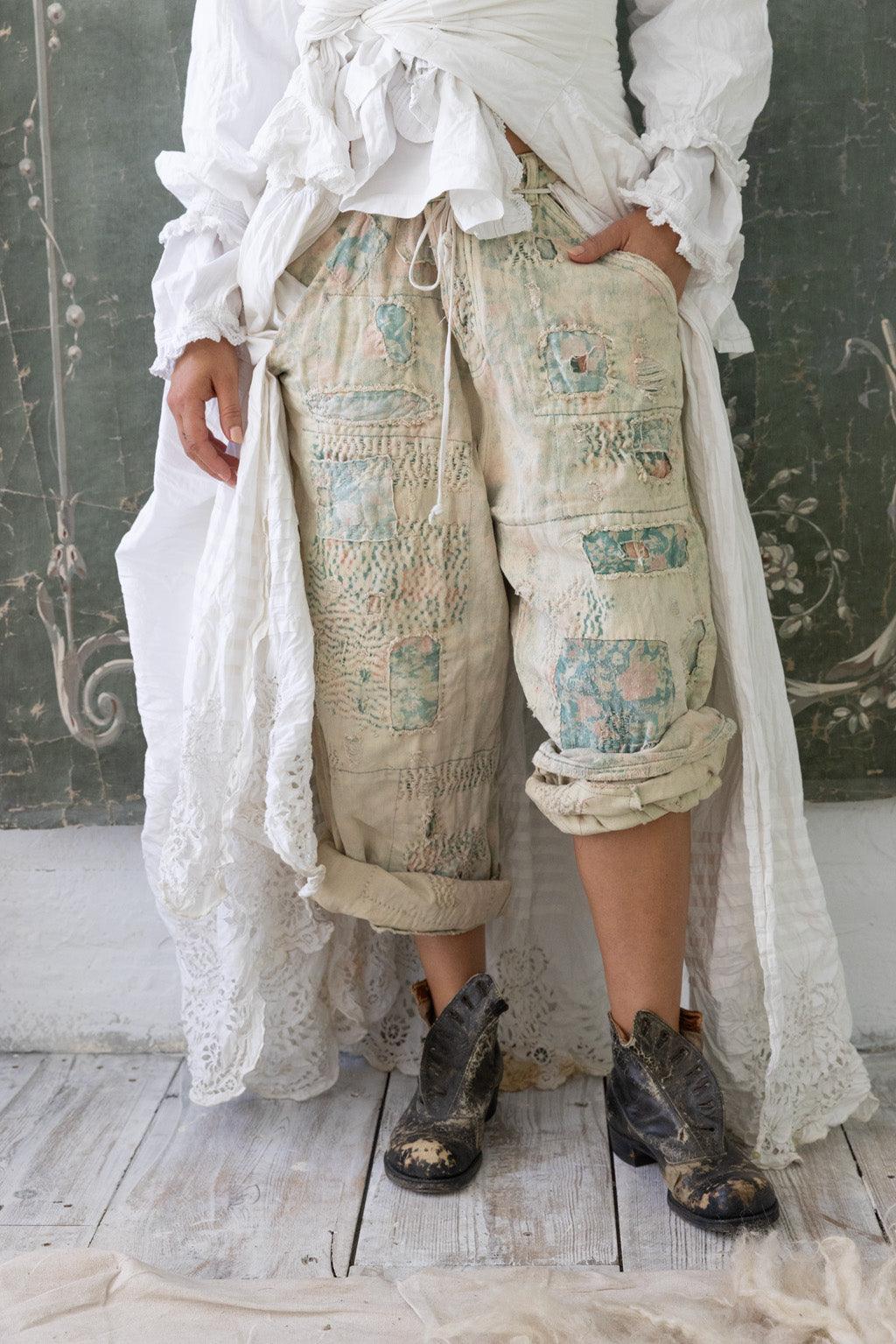 Magnolia Pearl artisan pants with whimsical vintage embroidery, white ruffled coat, rustic boots