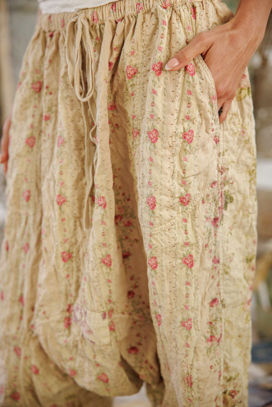 Magnolia Pearl artisan floral patchwork pants, whimsical vintage style, rustic boots, wooden floor