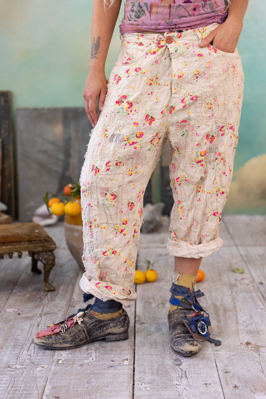 Magnolia Pearl artisan floral vintage patchwork pants, whimsical design, rustic setting