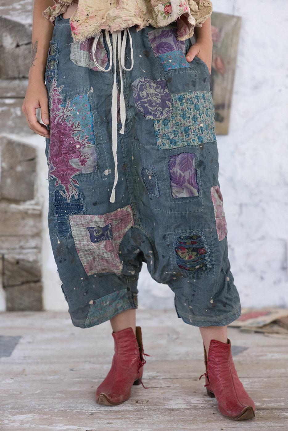 Woman wearing Magnolia Pearl artisan vintage-inspired patchwork pants and whimsical floral top