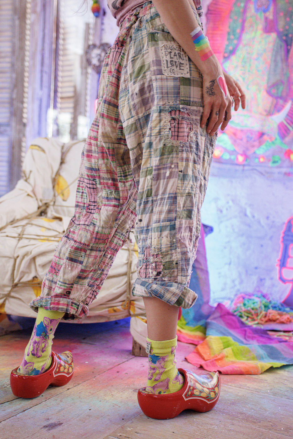 Magnolia Pearl patchwork artisan pants with whimsical vintage style, colorful socks, red clogs