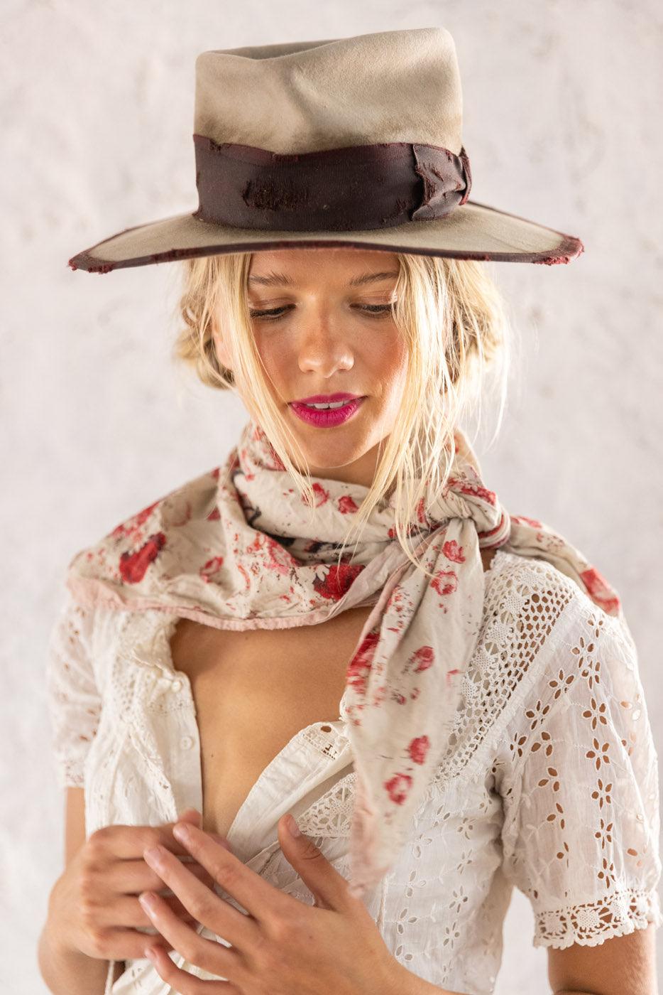 Magnolia Pearl artisan scarf with red floral print, vintage white dress, and whimsical hat