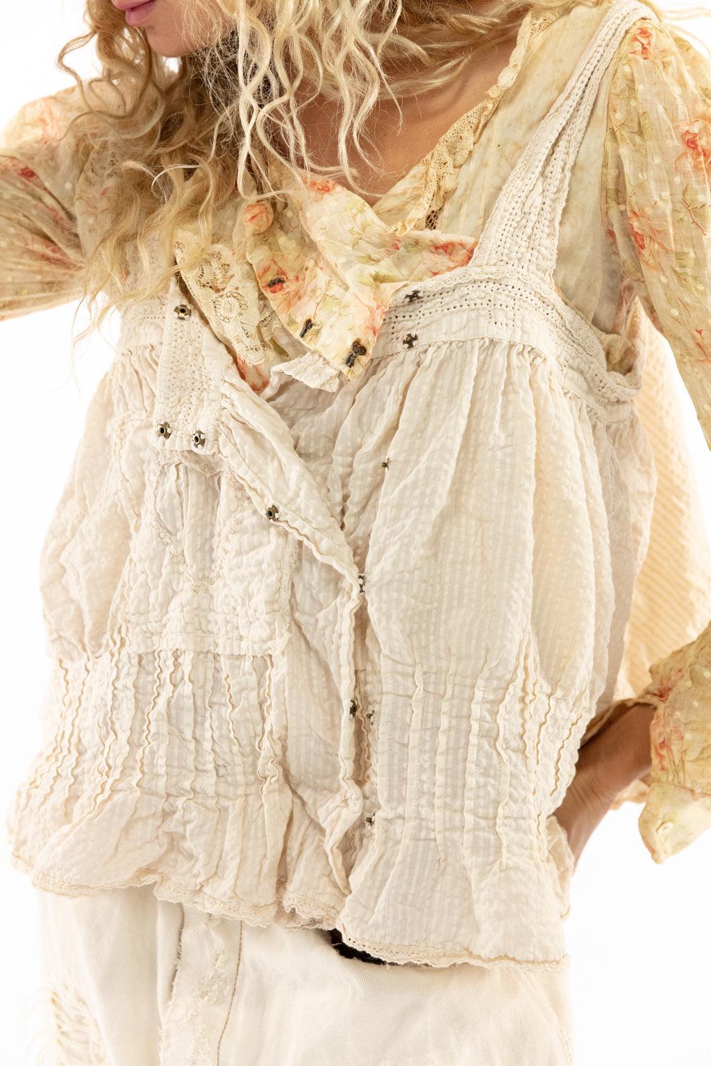 Magnolia Pearl model in artisan vintage distressed overalls, floral blouse, and whimsical top hat