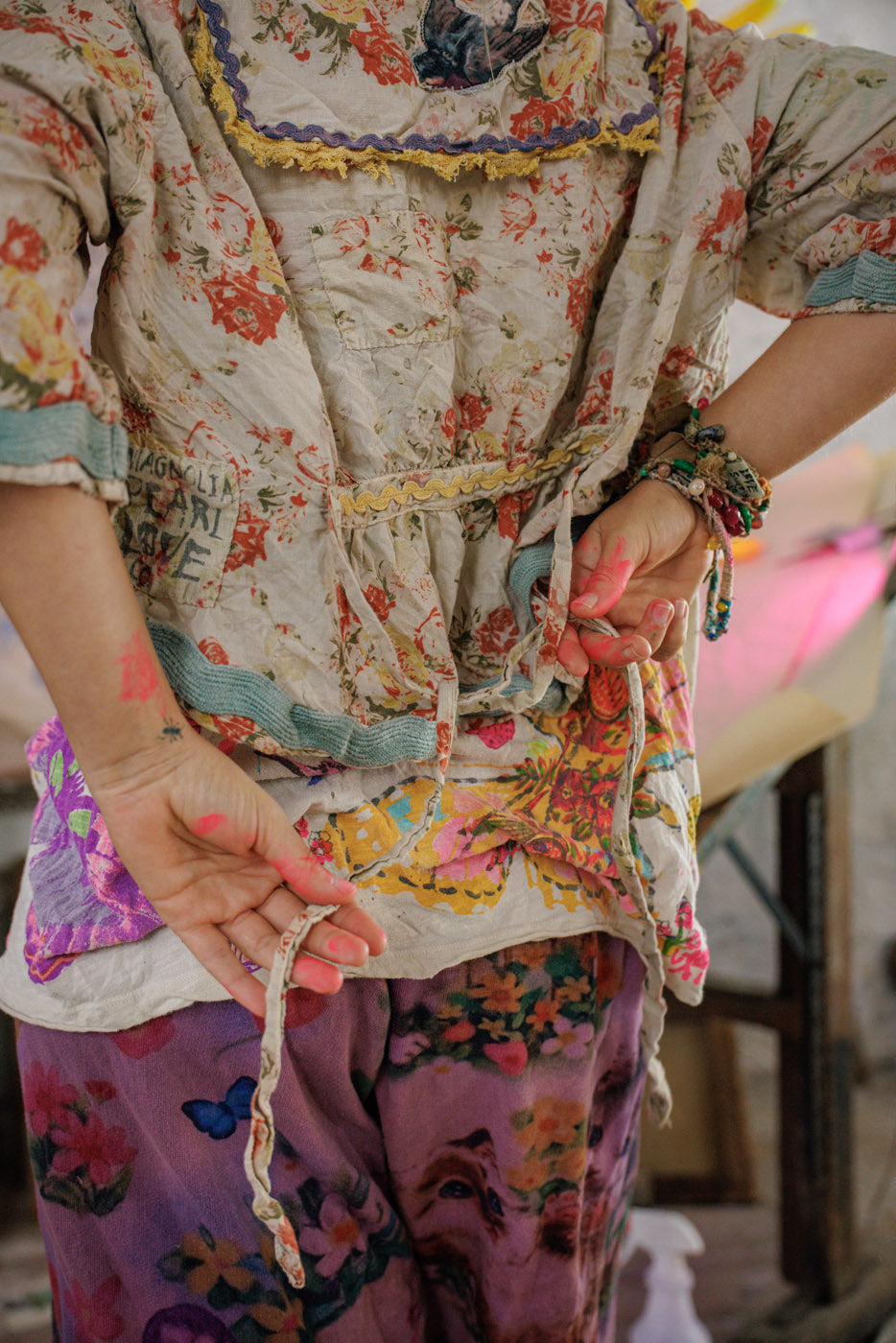 Magnolia Pearl vintage floral artisan blouse and whimsical patchwork pants with painted hands