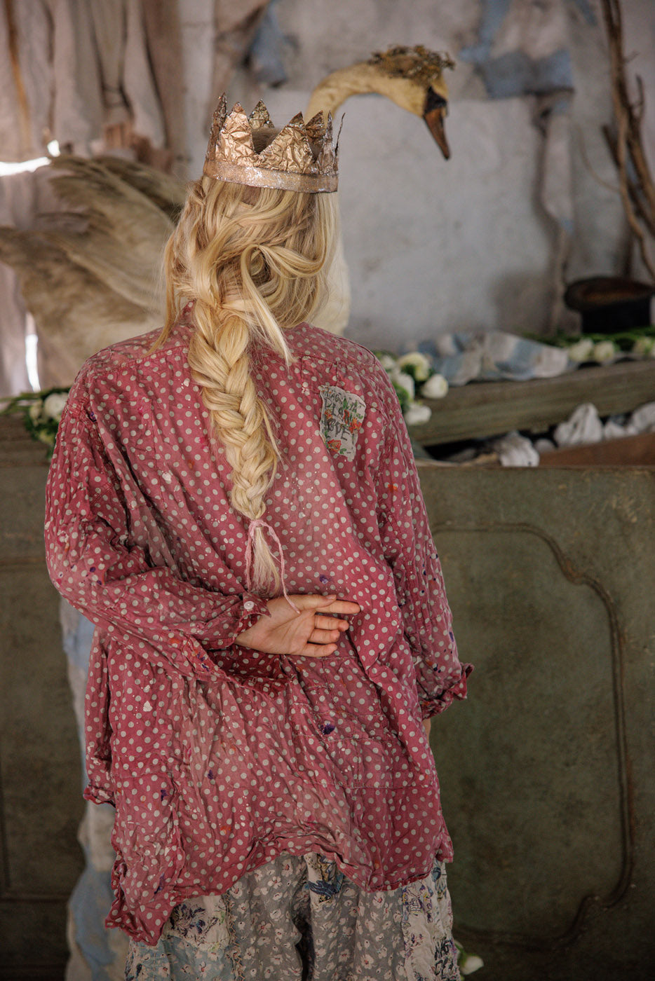 Woman in whimsical Magnolia Pearl polka dot top, gold crown, vintage artisan style