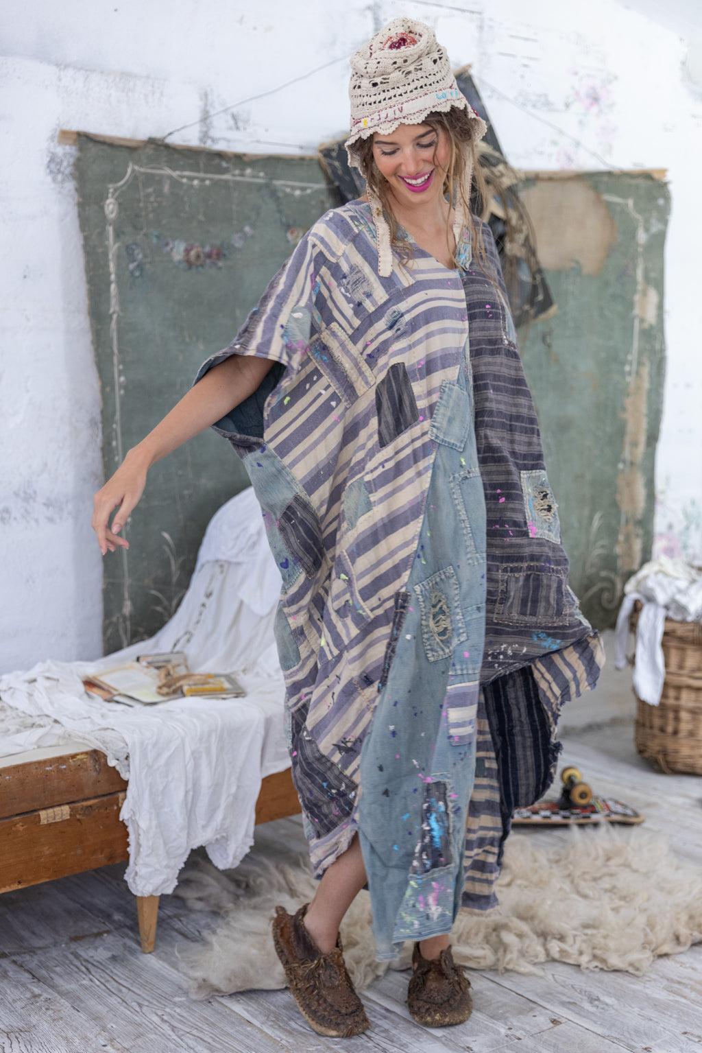 Woman in Magnolia Pearl artisan patchwork dress and crochet hat, vintage whimsical style bedroom