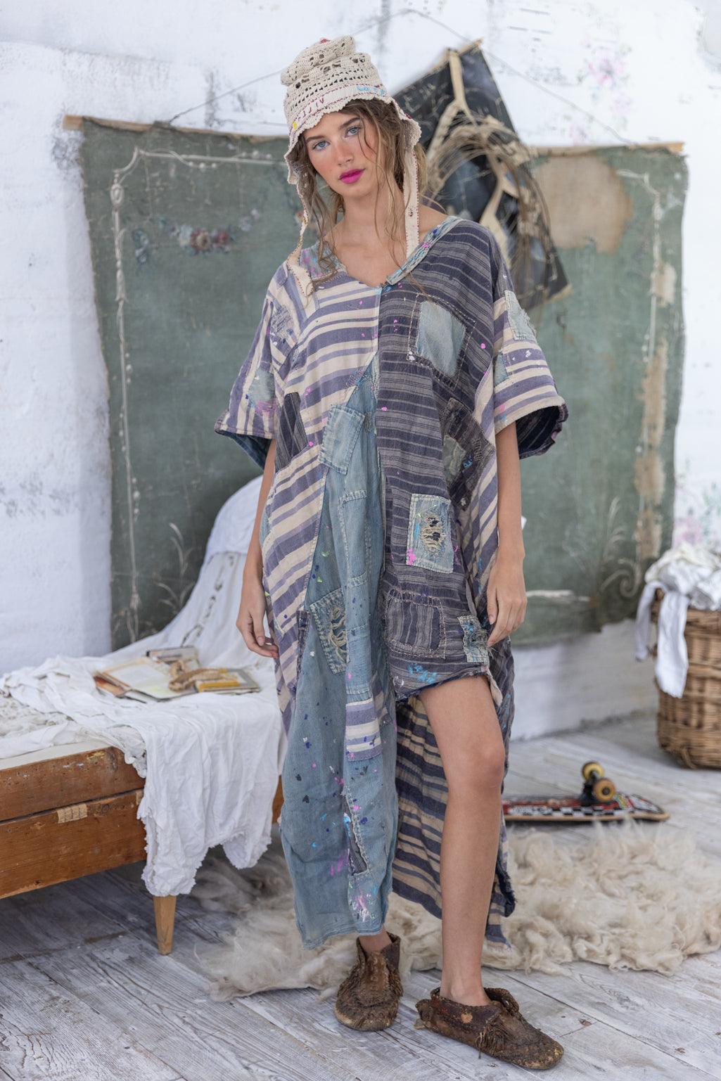 Woman in Magnolia Pearl artisan patchwork dress and crochet hat, vintage eclectic room