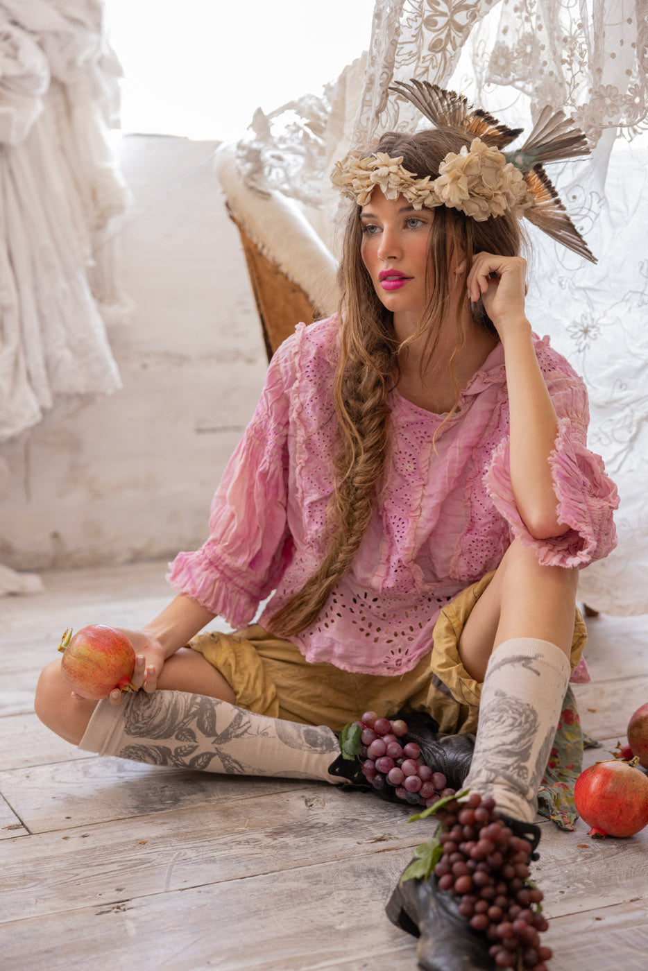 Woman in Magnolia Pearl artisan clothing, pink blouse, vintage lace, whimsical boho style, rustic decor
