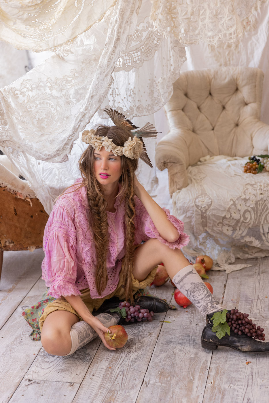 Woman in Magnolia Pearl artisan clothing, pink blouse, vintage lace, whimsical boho style, rustic decor