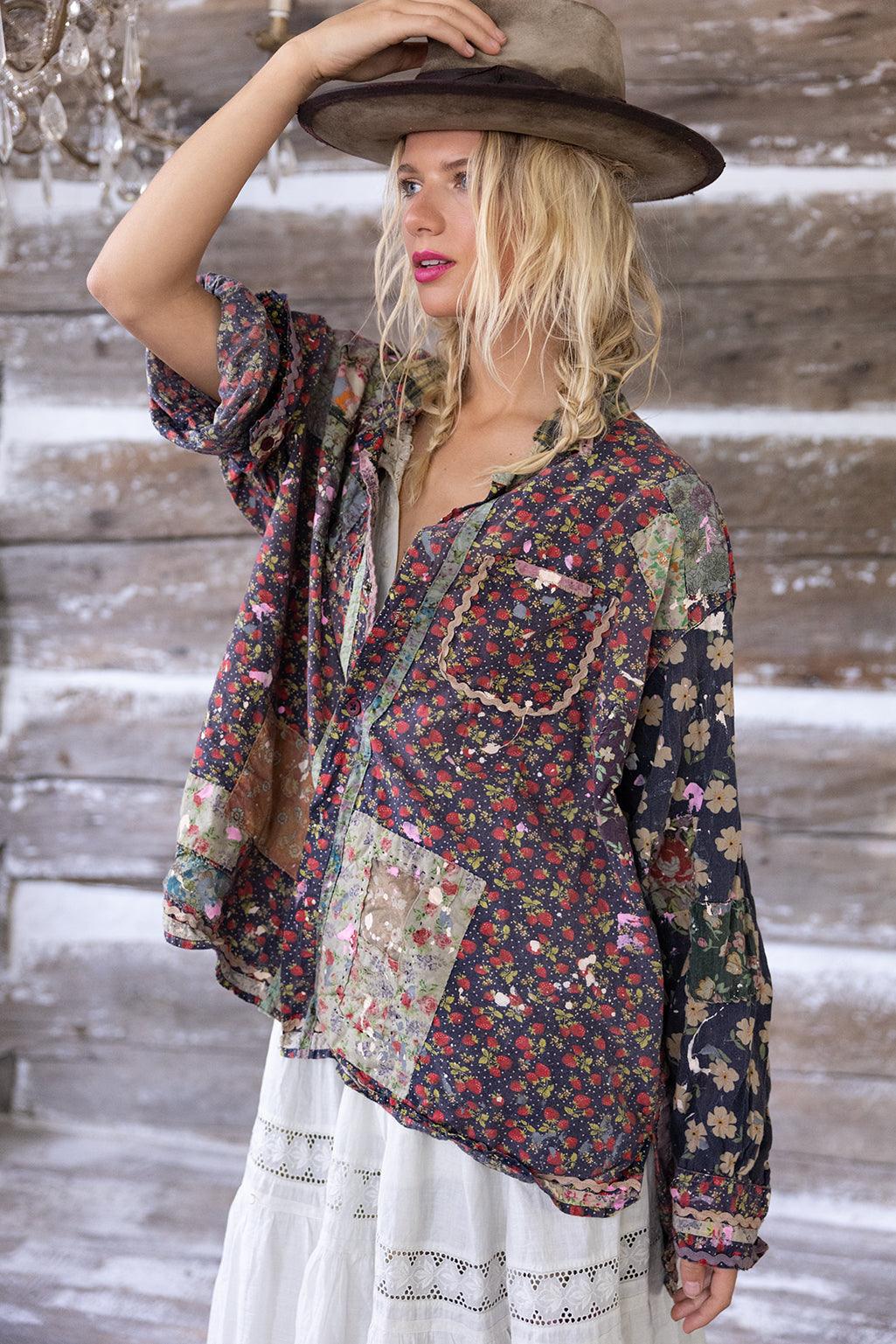 Woman in Magnolia Pearl artisan vintage floral patchwork shirt, rustic background, whimsical style