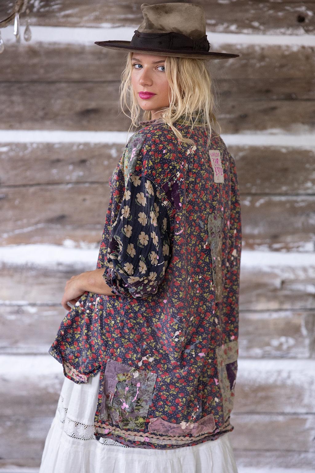 Woman in Magnolia Pearl floral patchwork artisan jacket and hat, vintage rustic style