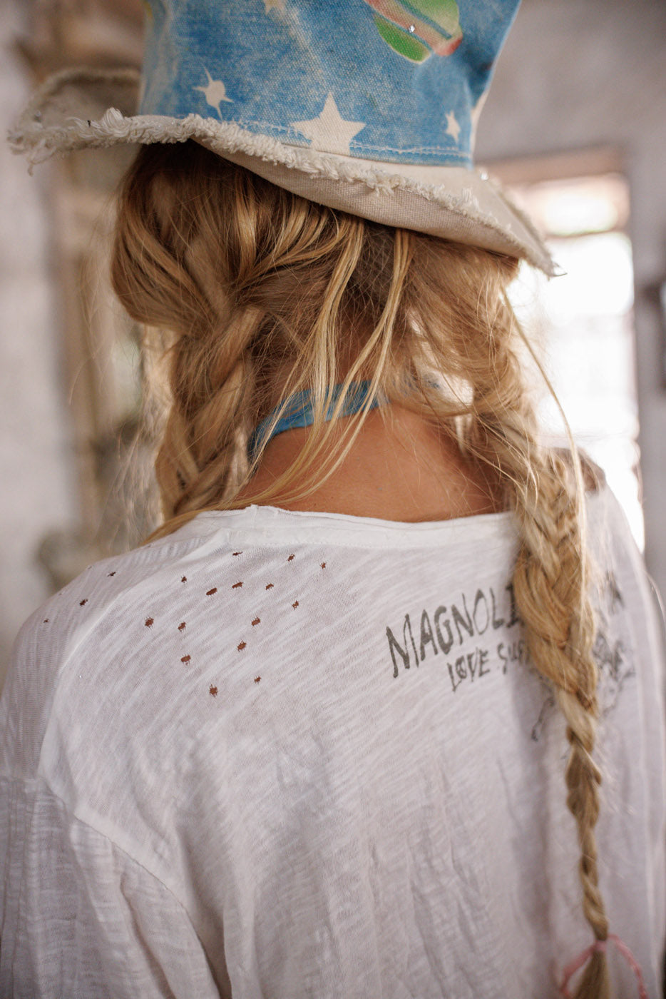 Magnolia Pearl artisan white top with whimsical text, vintage style, boho braids, blue star hat