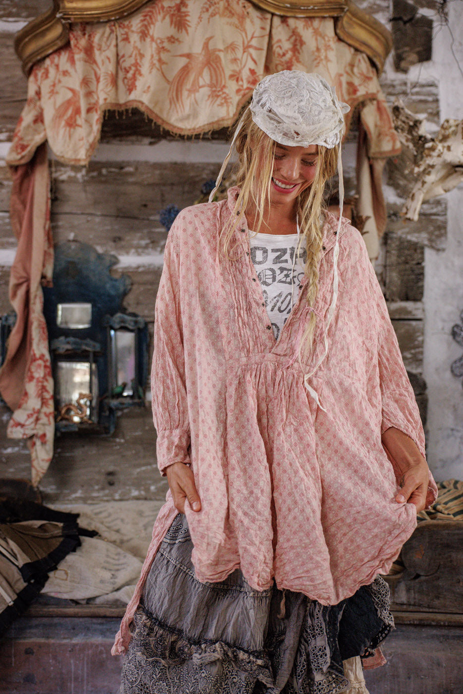 Woman in Magnolia Pearl vintage artisan dress, layered whimsical clothing, rustic boho setting