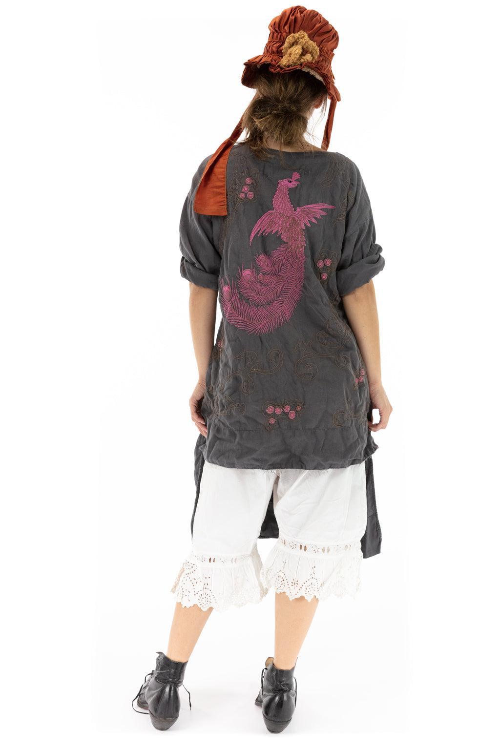 Woman in Magnolia Pearl artisan vintage-style embroidered tunic and red bonnet hat