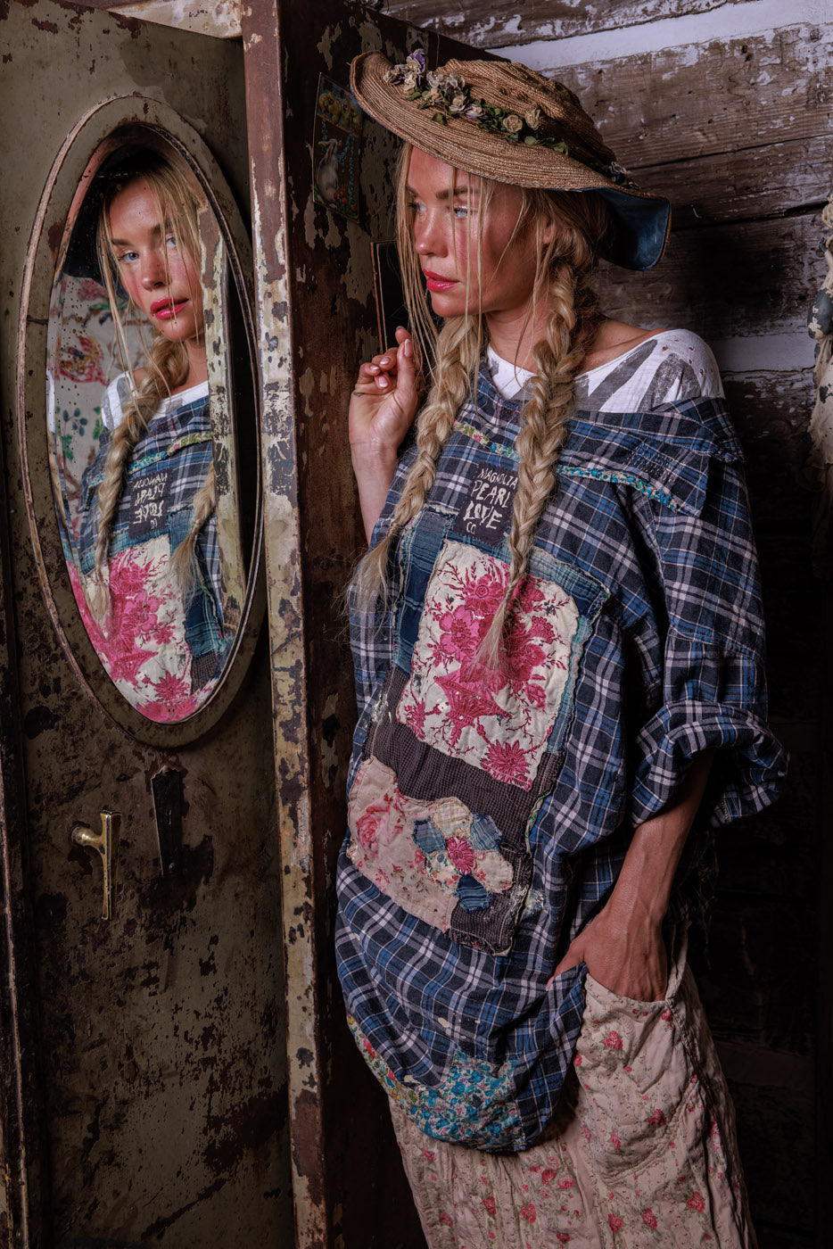 Magnolia Pearl model in vintage artisan patchwork clothing, straw hat, rustic setting, whimsical style