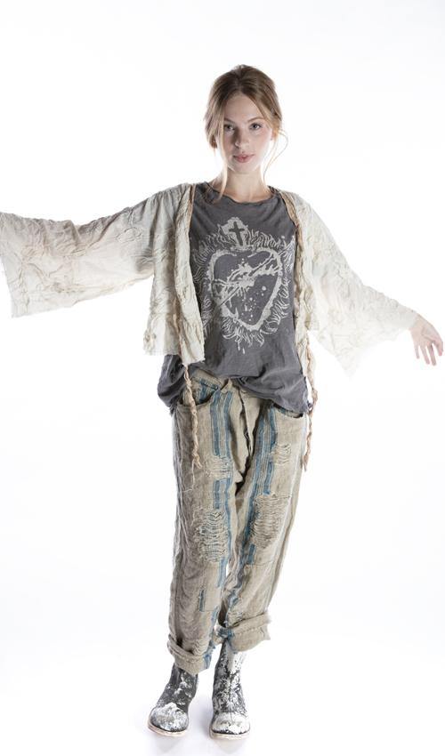 Woman in boho patchwork pants, graphic tee, sheer cream kimono jacket and boots